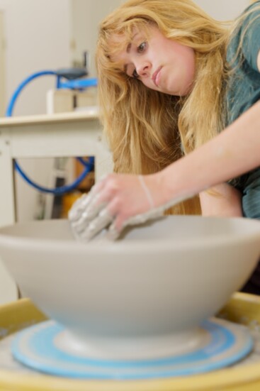 Kinsey Lane, throwing a stoneware bowl