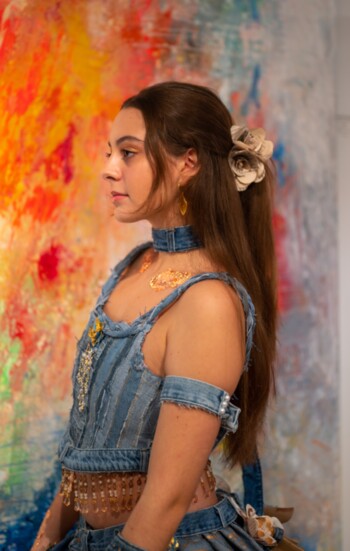 Andrea adorning Karina Papanikolaou’s denim dress, highlighting her views on sustainability in fashion.