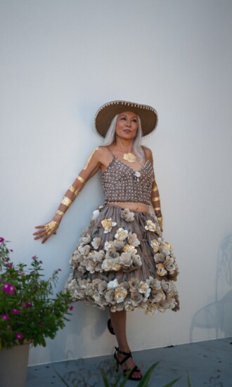 Ei Leen wearing Karina Papanikolaou’s plastic dress made entirely from collected plastic Publix bags and paper flowers made from discarded books.