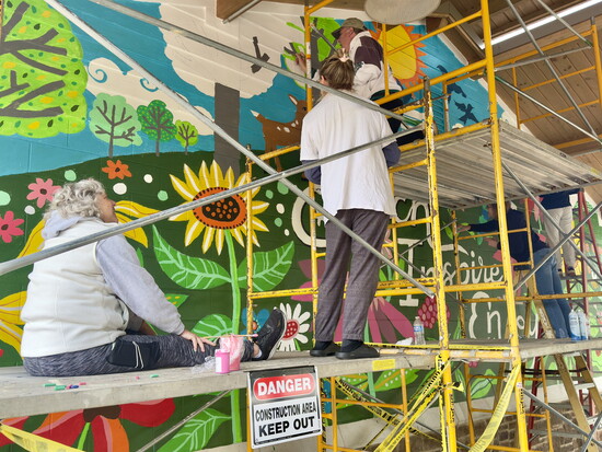 About 20 volunteers helped paint the mural.