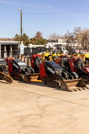 A row of Toro Dingo Walk Behind Skidsteers is among helpful labor-savign tools: carry an array of attachments including augers, hammers and tillers.