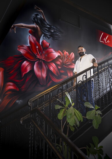 Dakhlallah in front of a dramatic and lovely mural