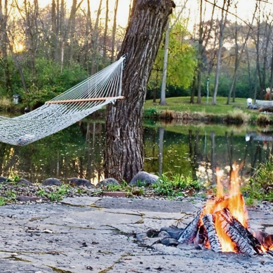 Brick patio with fire pit, next to the pond.