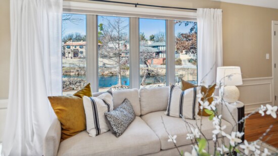 The large picture window anchors the main living room with spectacular views of Swan Lake.