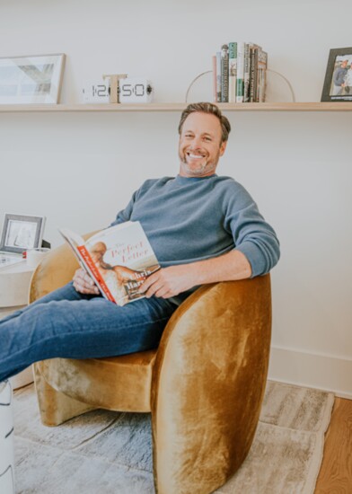 Chris in the office casually reading the first book he wrote 