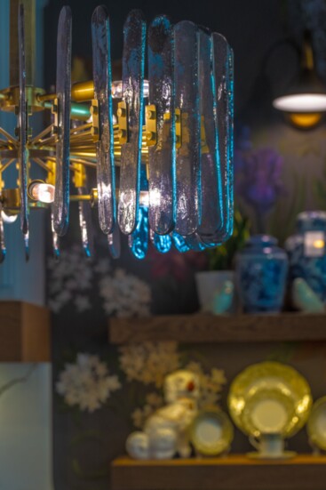 A unique smoked glass light fixture hangs in the studio kitchen.