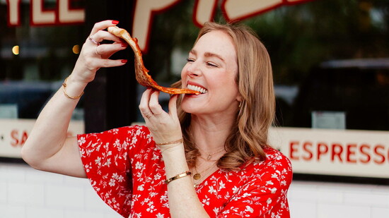 Shelby enjoying a slice of 'za at Homeslice.