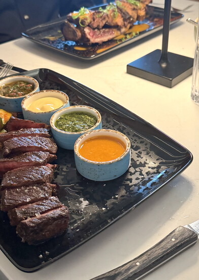 Steaks come with an assortment of housemade sauces: (l-r) red chimichurri, miso aioli, salsa verde, kimchi vin.