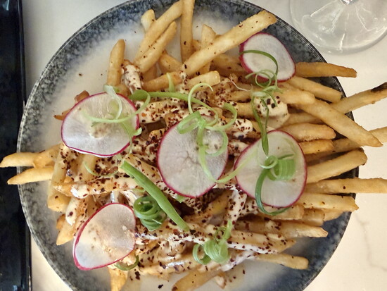 Fries are cooked in beef tallow then drizzled with the chef’s miso ranch sauce.