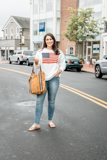 An oversized flag sweater has been a viral TikTok sensation for months. It pairs perfectly with embellished skinny jeans and tote. From Savvy + Grace.