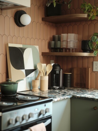 Pattern, texture, and light blend in the kitchen, enhanced by Vera Pawelzik's “Composition on Wood No.1” from Spalding Nix Gallery.