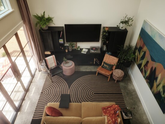 From the loft, the compact living space shines brightly, flooded with light through steel doors.