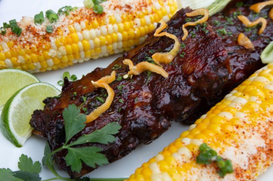 Papaya-Habanero BBQ baby back ribs with traditional Mexican elotes.