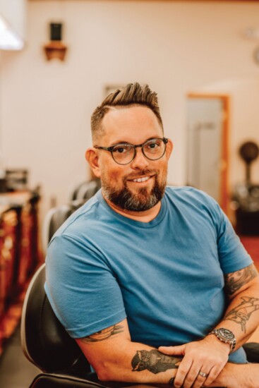Chris Martin, owner of Convoy Creatives, receives a Gentleman's hair cut with skin on the side and a hard part. (Stylist - Mandi Miller)