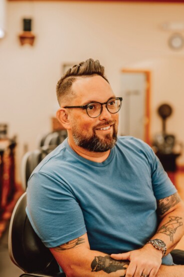 Chris Martin, owner of Convoy Creatives, receives a Gentleman's hair cut with skin on the side and a hard part. (Stylist - Mandi Miller)