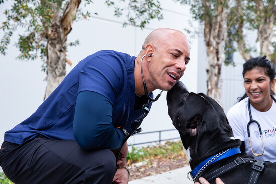 A kiss on the cheek — proof of the bond Stewart nurtures on every street corner