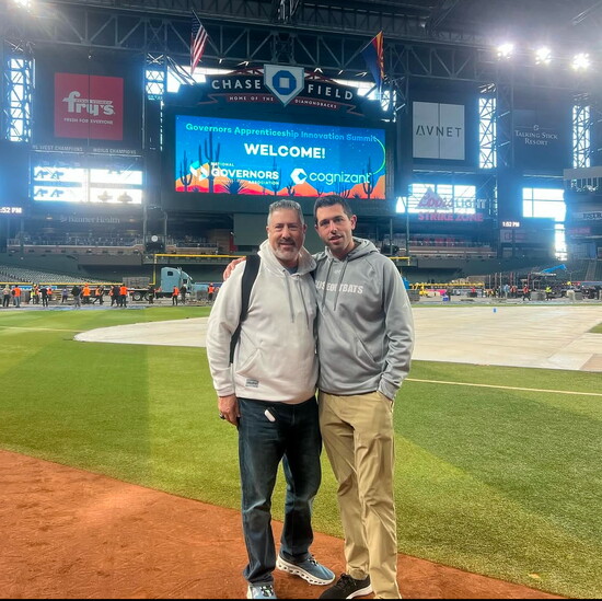Roy and Max Zitomer on the field at a baseball game