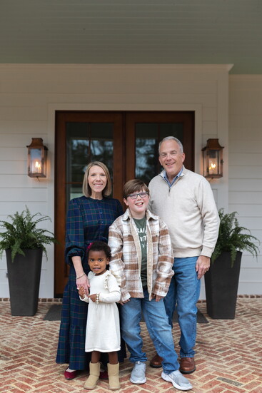 Homeowners Amanda and Tommy and their children, Elizabeth and Henry, on their stately front porch. 