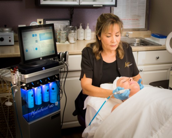 Cheryl Sutton, licensed aesthetician, performs a HydraFacial MD treatment.