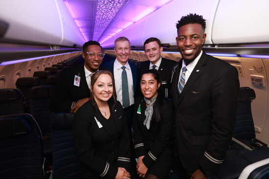 United Airlines CEO Scott Kirby poses with the flight crew aboard United’s newest aircraft, the Airbus A321neo