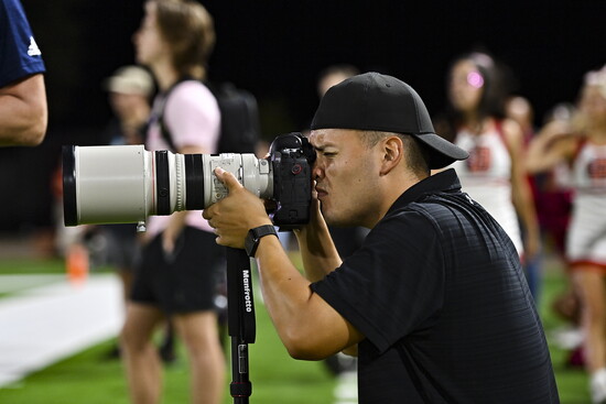 Daniel photographs a Cy-Fair ISD high school football game at the Berry Center