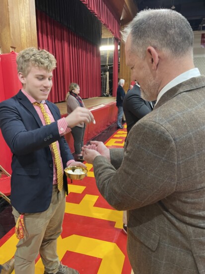 BC student giving out Holy Communion during a school Mass