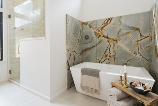 This bathroom features an elegant freestanding tub. The 6’ tall Blue Cascade Quartzite adds a bold touch to an otherwise spa-like setting.