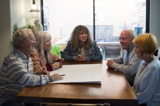 A client meets with Mike and Sandy Kiefner to go over their plan design for a future home in North Shore. (Photo by Michelle Pipes)