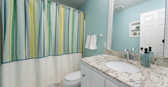 A total makeover! New vanity, sink, faucet and granite, as well as custom-framed mirror with new light fixture, shower curtain, towels and accessories.  