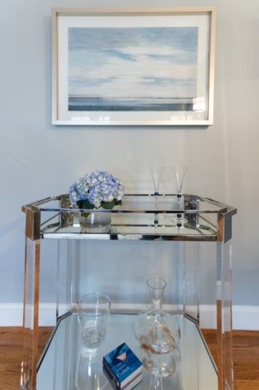 Dining room decadence— new lamps, a mirror and bar cart were added to complete the room.