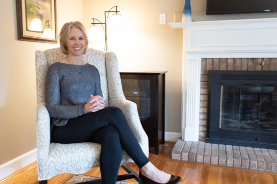 Unwinding in a wingback, Bridget Krebs loves her new reupholstered chairs.  