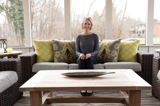 Bridget Krebs, at home on her colorful new custom couch