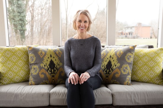 Bridget Krebs, at home on her colorful new custom couch