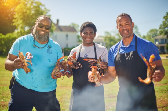 Bahli Mullins, Brysen Mullins and Antonio Vincent getting lobsters on the crab bake.