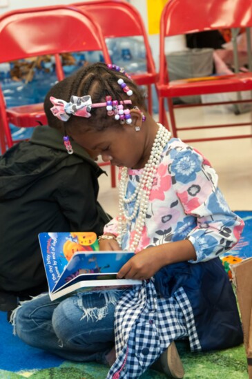 Reading books donated by the Christ Child Society