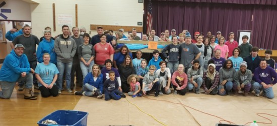 Volunteer workers pose at Amanda Elementary during a February Build Day. where they built 20 beds.