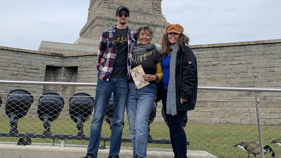Charlotte, her daughter, and grandson visiting the Statue of Liberty
