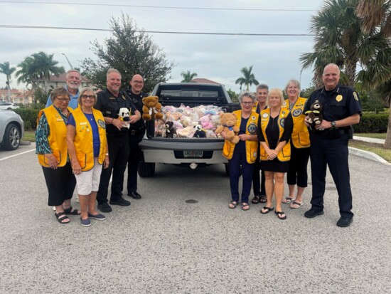 Sergeant Hammett with Venice Police officers receive 130 new teddy bears donated by the Venice Lions Club. Officers give them to children in scary situations.