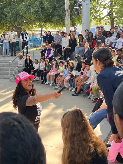 Rocket scientist Dr. Michaelyn Thomas passes the mic — and the inspiration — to a Westerly student during the school's Black History Month assembly.