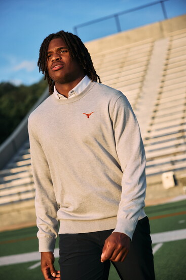 M+M's white solid Leeward dress shirt, light gray heather University of Texas heritage crewneck sweater, black Helmsman chinos.