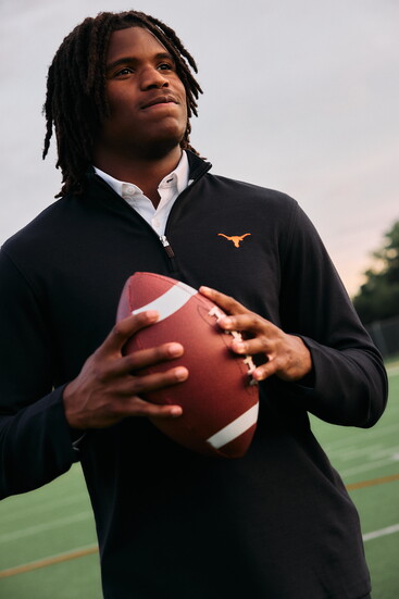 Ryan is wearing Mizzen + Main's white solid Leeward dress shirt, black solid University of Texas KPI quarterzip.
