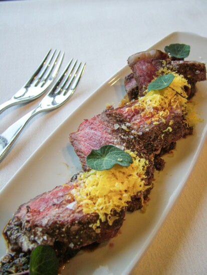 Beef Carpaccio prime Iowa filet mignon, crispy capers, pickled mustard seeds, arugula, crostini, and parmesan cheese