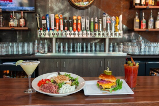 The Backyard Burger with American cheese and all the fixings, and the Signature Cobb with chicken, bacon, tomato, egg and bleu cheese on a bed of greens.