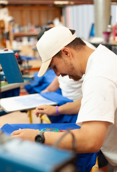 Once a one-at-a-time process, Blue Ribbon now uses advanced machines along with faithful employees to streamline the screen printing process.