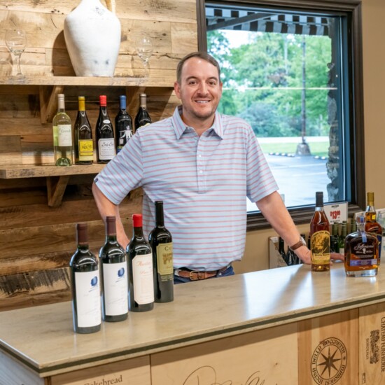 Adam Sinks shows off the portable bar used for in-store beverage tastings.