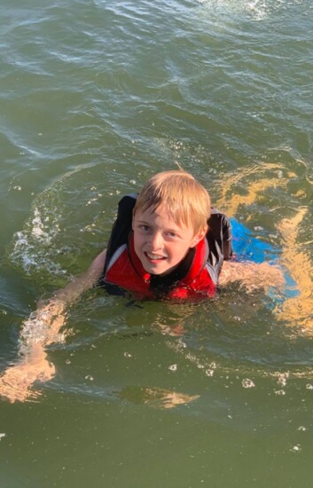 Ty Gurley wears his life jacket while swimming.