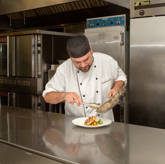 Chef JP carefully plates his creation, a heart-healthy grilled chicken marsala with Yukon gold potatoes and fresh, sautéed vegetables