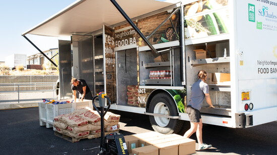 NI Volunteer Darin Lyons (l) and Lennon Lott (r) load the NI Mobile Pantry for food deliveries. 