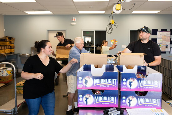 (l to r): Natalia Romero (volunteer), Sam Nielsen (Food Bank Partner Specialist), Vern Bjerk (volunteer), Emma and Tyler (volunteers) pack Fresh Express boxes.