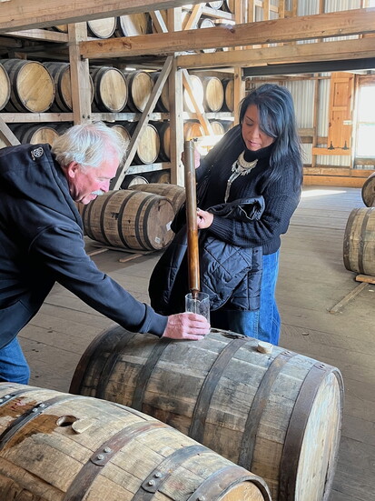 Whiskey thieving for a taste of bourbon straight from the barrel.
